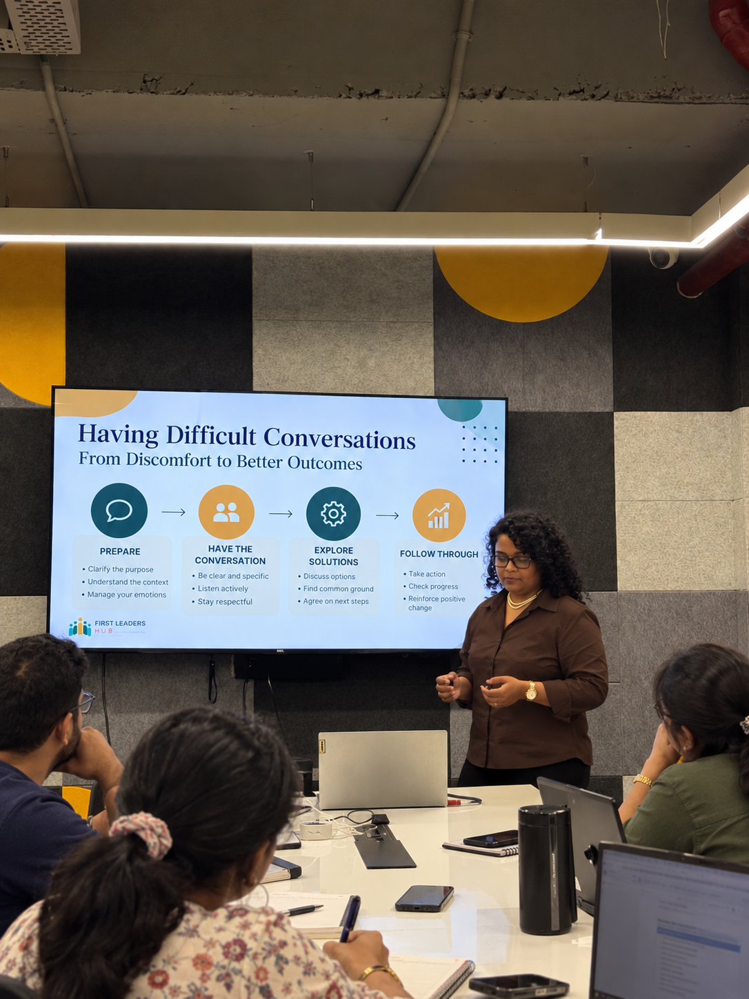 Deepa Panikkaveetil facilitating a workshop on difficult conversations for a group of participants.